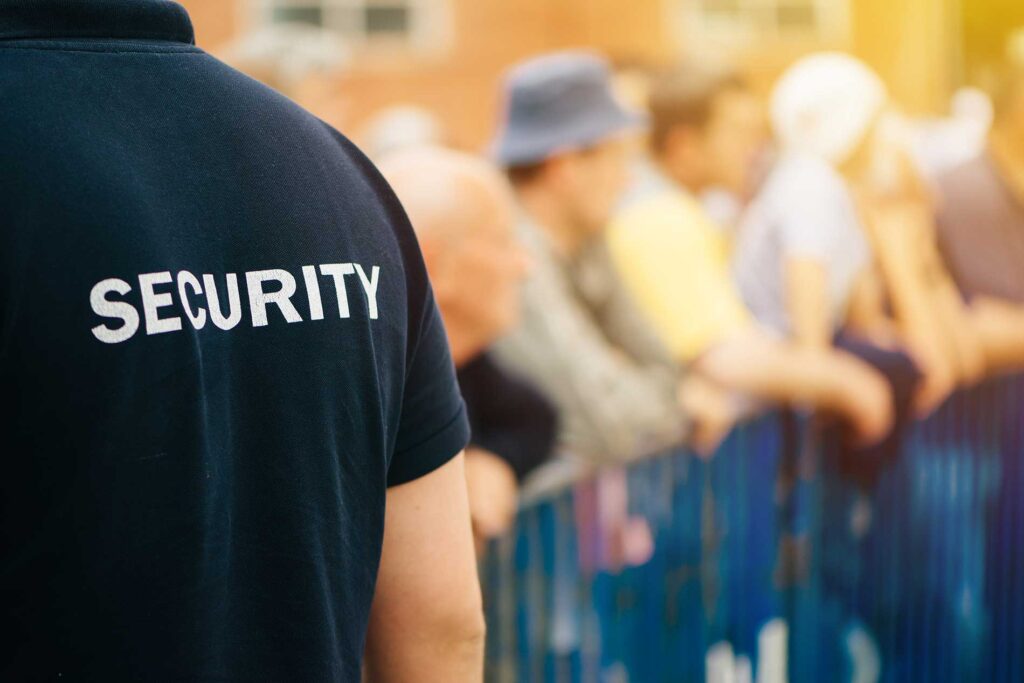 security guard looking over a crowd of people