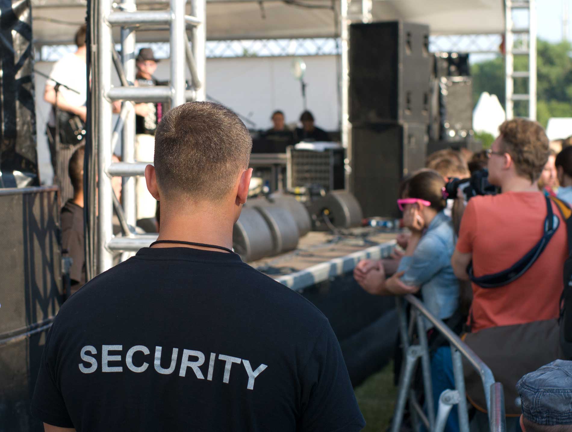 security in an outside concert watching the crowd