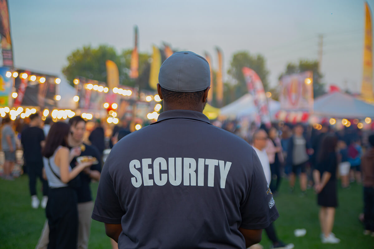 A security guard is controlling the traffic A security guard is controlling the traffic